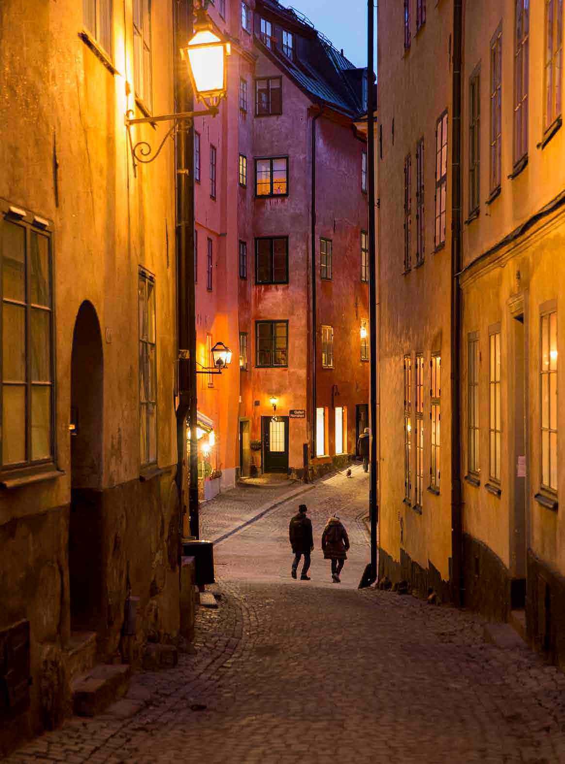 Las lámparas iluminan los callejones que conducen a Köpmantorget (plaza de los comerciantes) en la oscuridad de Gamla Stan