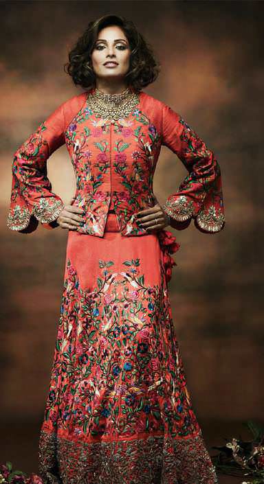 Parsi ghara work jacket lehenga with zardozi on bell sleeves & lehenga border by Pooja Shroff; 22k gold choker with white parabs, green onyx,red garnets in traditional nakshi carving by Manubhai Jewellers